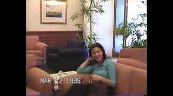Movie still from “Searching for Sugar Man” (2012), directed by Malik Bendjelloul – A woman sitting on a couch talking on the phone; Medium shot, High angle