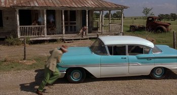 Movie still from “Secondhand Lions” (2003), directed by Tim McCanlies – An old car parked in front of an old house; Wide shot, Over the shoulder angle
