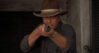 Movie still from “Secondhand Lions” (2003), directed by Tim McCanlies – An older man wearing a hat and holding a gun; Close Up shot, Low angle