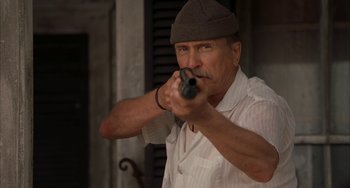 Movie still from “Secondhand Lions” (2003), directed by Tim McCanlies – An older man holding a gun in his hand; Close Up shot, Low angle