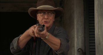 Movie still from “Secondhand Lions” (2003), directed by Tim McCanlies – An older man wearing a hat and holding a gun; Close Up shot, Low angle