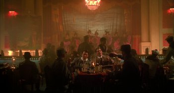 Movie still from “Secondhand Lions” (2003), directed by Tim McCanlies – A group of people sitting at a table in front of a stage; Wide shot, High angle
