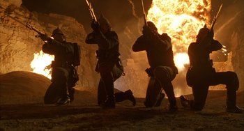 Movie still from “Secondhand Lions” (2003), directed by Tim McCanlies – A group of men in military gear holding guns; Wide shot, Low angle