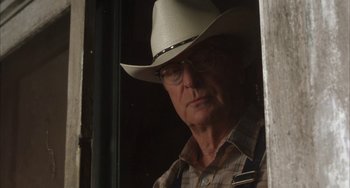 Movie still from “Secondhand Lions” (2003), directed by Tim McCanlies – An older man wearing a cowboy hat looking out of a window; Close Up shot, Low angle