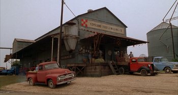 Movie still from “Secondhand Lions” (2003), directed by Tim McCanlies – An old truck parked in front of an old building; Extreme Wide shot, Low angle