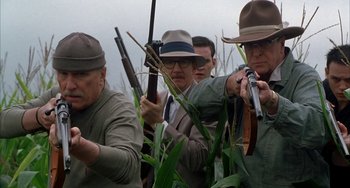 Movie still from “Secondhand Lions” (2003), directed by Tim McCanlies – A group of men holding guns in a corn field; Medium shot, Low angle