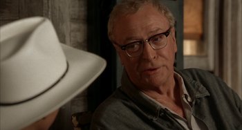 Movie still from “Secondhand Lions” (2003), directed by Tim McCanlies – An older man wearing glasses looking at a hat; Close Up shot, Over the shoulder angle