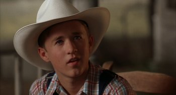 Movie still from “Secondhand Lions” (2003), directed by Tim McCanlies – A young man wearing a white cowboy hat; Close Up shot, Over the shoulder angle