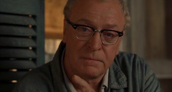 Movie still from “Secondhand Lions” (2003), directed by Tim McCanlies – An older man wearing glasses and a jean jacket; Close Up shot, Over the shoulder angle