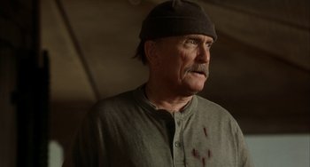 Movie still from “Secondhand Lions” (2003), directed by Tim McCanlies – An older man with a hat and some blood on his face; Close Up shot, Low angle