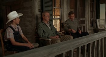 Movie still from “Secondhand Lions” (2003), directed by Tim McCanlies – A group of people sitting on a porch; Medium shot, Over the shoulder angle