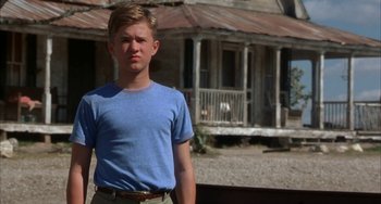 Movie still from “Secondhand Lions” (2003), directed by Tim McCanlies – A young man standing in front of a house; Medium shot, Low angle