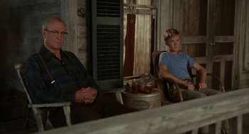 Movie still from “Secondhand Lions” (2003), directed by Tim McCanlies – Two men sitting in chairs in front of a window; Medium shot, Low angle
