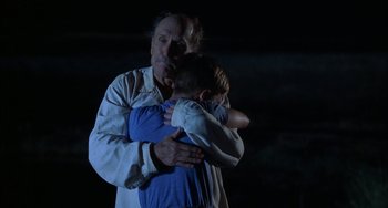 Movie still from “Secondhand Lions” (2003), directed by Tim McCanlies – An older man holding a young boy in his arms; Medium shot, Over the shoulder angle