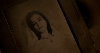 Movie still from “Secondhand Lions” (2003), directed by Tim McCanlies – An old photo of a woman in a white dress; Extreme Close Up shot, High angle