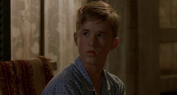 Movie still from “Secondhand Lions” (2003), directed by Tim McCanlies – A young man in a polka dot shirt looking at the camera; Close Up shot, Low angle