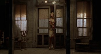 Movie still from “Secondhand Lions” (2003), directed by Tim McCanlies – A woman standing in front of an open screen door; Wide shot, Low angle