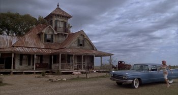 Movie still from “Secondhand Lions” (2003), directed by Tim McCanlies – An old car parked in front of an abandoned house; Wide shot, Low angle