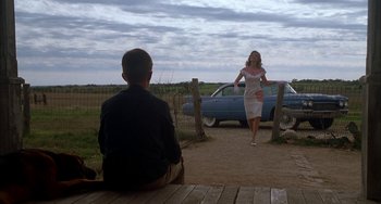 Movie still from “Secondhand Lions” (2003), directed by Tim McCanlies – A man and a woman sitting on a wooden bench; Wide shot, Over the shoulder angle
