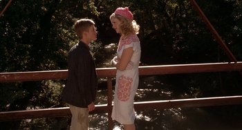 Movie still from “Secondhand Lions” (2003), directed by Tim McCanlies – A woman and a young boy standing next to each other on a bridge; Medium shot, Low angle