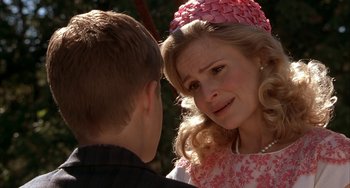 Movie still from “Secondhand Lions” (2003), directed by Tim McCanlies – A woman in a pink hat is talking to a young boy; Close Up shot, Over the shoulder angle