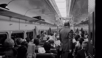 Movie still from “Seconds” (1966), directed by John Frankenheimer – Black and white photograph of people on a subway train; Wide shot, High angle