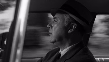Movie still from “Seconds” (1966), directed by John Frankenheimer – A black and white photo of a man in a suit and hat; Close Up shot, Low angle