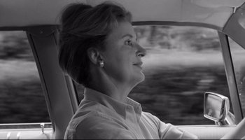 Movie still from “Seconds” (1966), directed by John Frankenheimer – A black and white photo of a woman driving a car; Close Up shot, Over the shoulder angle