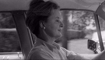 Movie still from “Seconds” (1966), directed by John Frankenheimer – An older woman sitting in the driver's seat of a car; Close Up shot, Over the shoulder angle
