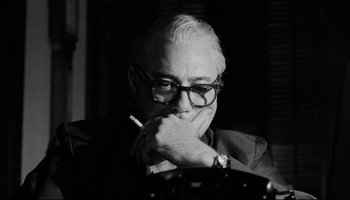 Movie still from “Seconds” (1966), directed by John Frankenheimer – An older man with glasses is smoking a cigarette; Close Up shot, Low angle