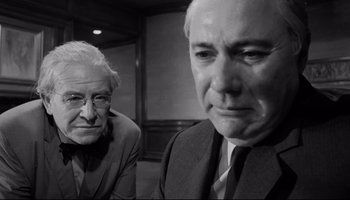 Movie still from “Seconds” (1966), directed by John Frankenheimer – Two older men in suits and ties looking at each other; Close Up shot, Low angle