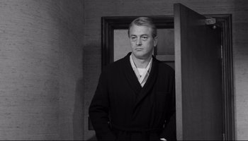 Movie still from “Seconds” (1966), directed by John Frankenheimer – Black and white photograph of a man in a bathrobe; Medium shot, Low angle