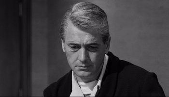 Movie still from “Seconds” (1966), directed by John Frankenheimer – An older man in a black jacket is looking at the camera; Close Up shot, Low angle