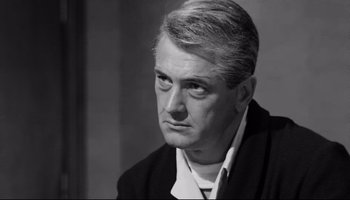 Movie still from “Seconds” (1966), directed by John Frankenheimer – An older man in a black jacket and white shirt; Close Up shot, Over the shoulder angle