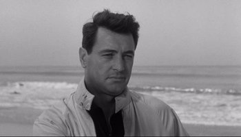 Movie still from “Seconds” (1966), directed by John Frankenheimer – Black and white photograph of a man at the beach; Close Up shot, Over the shoulder angle