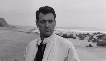 Movie still from “Seconds” (1966), directed by John Frankenheimer – A black and white photo of a man on the beach; Close Up shot, Low angle