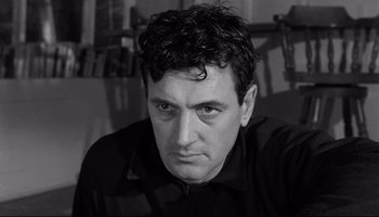 Movie still from “Seconds” (1966), directed by John Frankenheimer – Black and white photograph of a man in a black shirt; Close Up shot, Low angle