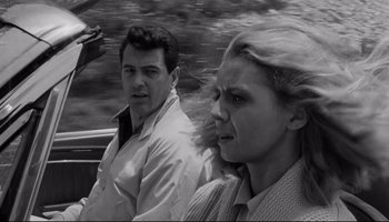 Movie still from “Seconds” (1966), directed by John Frankenheimer – A man and a woman are riding in a car together; Close Up shot, Low angle