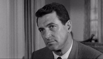 Movie still from “Seconds” (1966), directed by John Frankenheimer – Black and white photograph of a man in a suit and tie; Close Up shot, Low angle