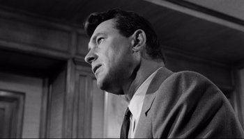 Movie still from “Seconds” (1966), directed by John Frankenheimer – Black and white photograph of a man in a suit; Close Up shot, Low angle