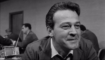 Movie still from “Seconds” (1966), directed by John Frankenheimer – Black and white photograph of a man smiling for the camera; Close Up shot, Low angle