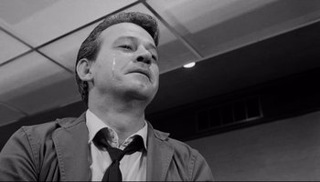 Movie still from “Seconds” (1966), directed by John Frankenheimer – Black and white photograph of a man in a tie; Close Up shot, Low angle