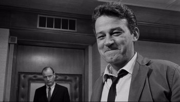 Movie still from “Seconds” (1966), directed by John Frankenheimer – A black - and - white photo of two men in suits; Close Up shot, Low angle