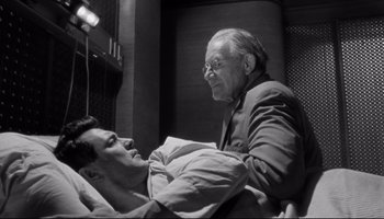 Movie still from “Seconds” (1966), directed by John Frankenheimer – An older man and a younger man in a hospital bed; Medium shot, Low angle