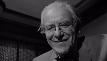 Movie still from “Seconds” (1966), directed by John Frankenheimer – An older man with glasses smiling for the camera; Close Up shot, Low angle