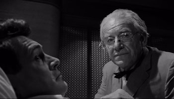 Movie still from “Seconds” (1966), directed by John Frankenheimer – An older man and a younger man are looking at each other; Close Up shot, Low angle