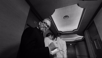 Movie still from “Seconds” (1966), directed by John Frankenheimer – A black and white photo of a man in a suit and tie; Medium shot, Low angle