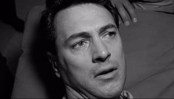 Movie still from “Seconds” (1966), directed by John Frankenheimer – Black and white photograph of a man looking at the camera; Close Up shot, High angle