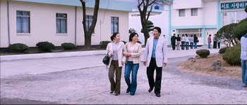 Movie still from “Secret Sunshine” (2007), directed by Lee Chang-dong – A group of people walking down a street; Wide shot, High angle