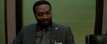 Movie still from “Secret in Their Eyes” (2015), directed by Billy Ray – A man wearing a suit and tie smiling; Close Up shot, Over the shoulder angle